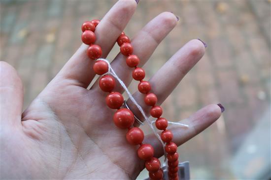 A single strand graduated coral bead necklace, with yellow metal clasp, gross weight 53 grams, 64cm.